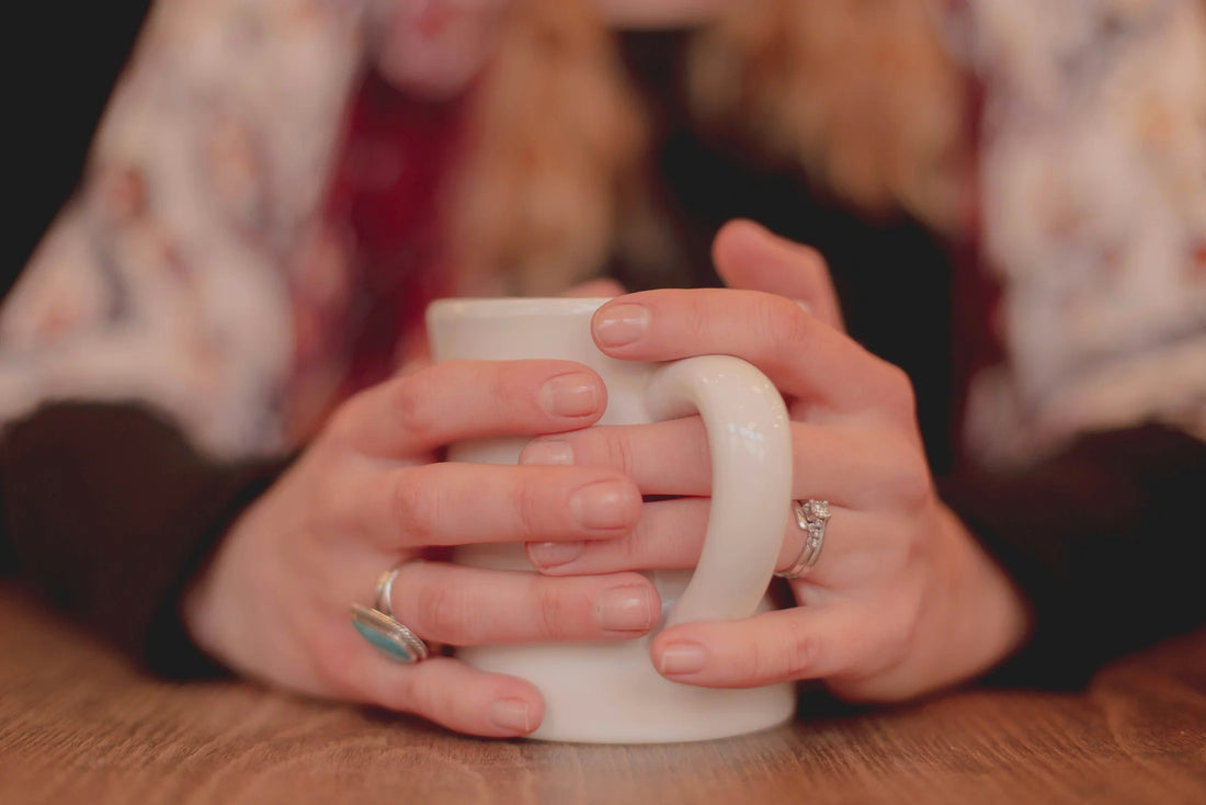Death Doula holding a coffee mug