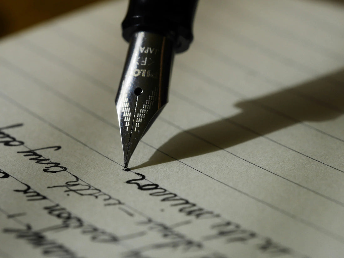 Someone using an ink pen to write a eulogy