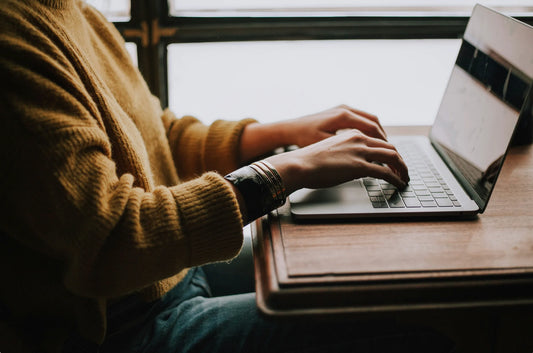 A woman creating a memorial website on a laptop