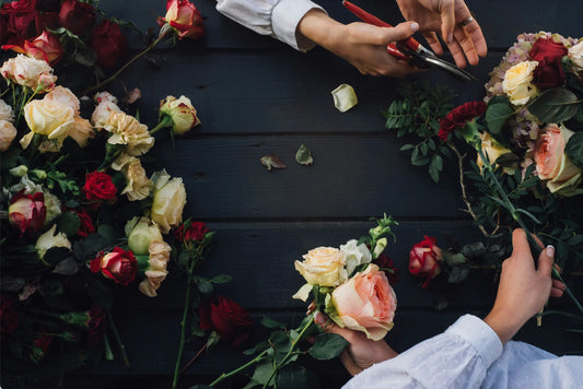 Hands putting together florals for a funeral