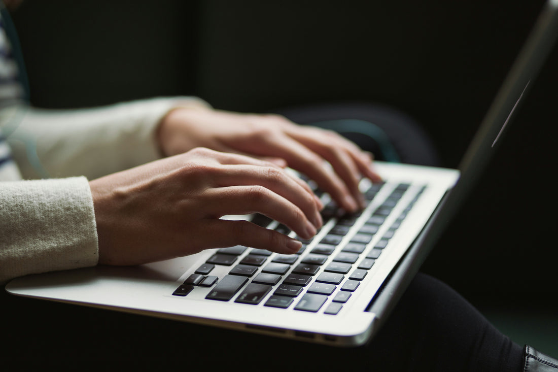 Someone typing an email inquiry to a funeral home