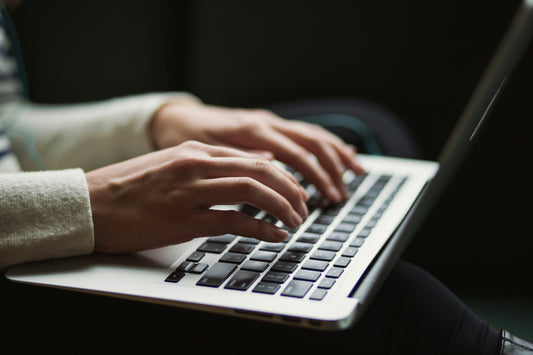 Someone typing an email inquiry to a funeral home