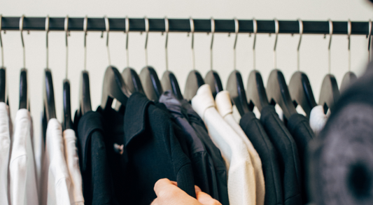 What to wear to a funeral. Hand grabbing black shirt out of closet