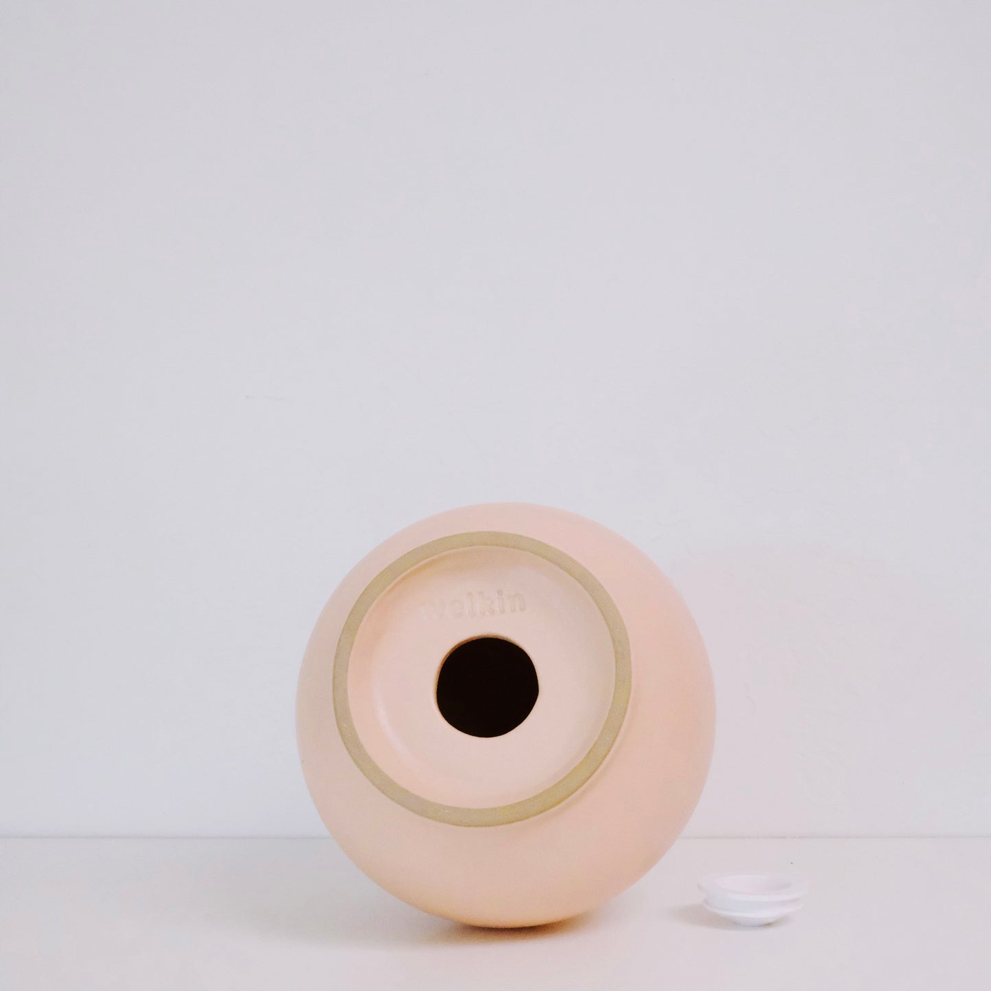 The bottom of a welkin urn with the plug out