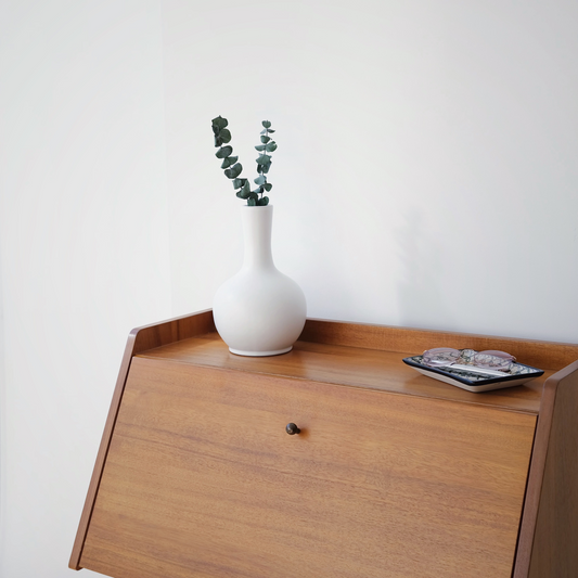 Small urn sitting on a desk