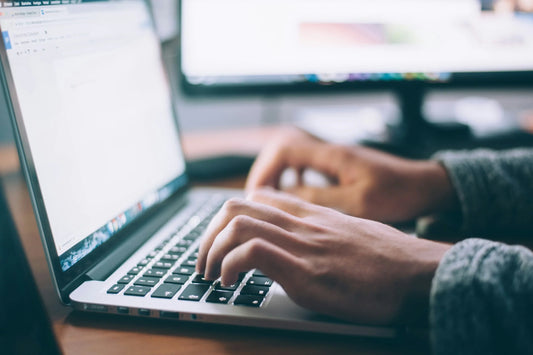 A woman typing out the outline of a eulogy