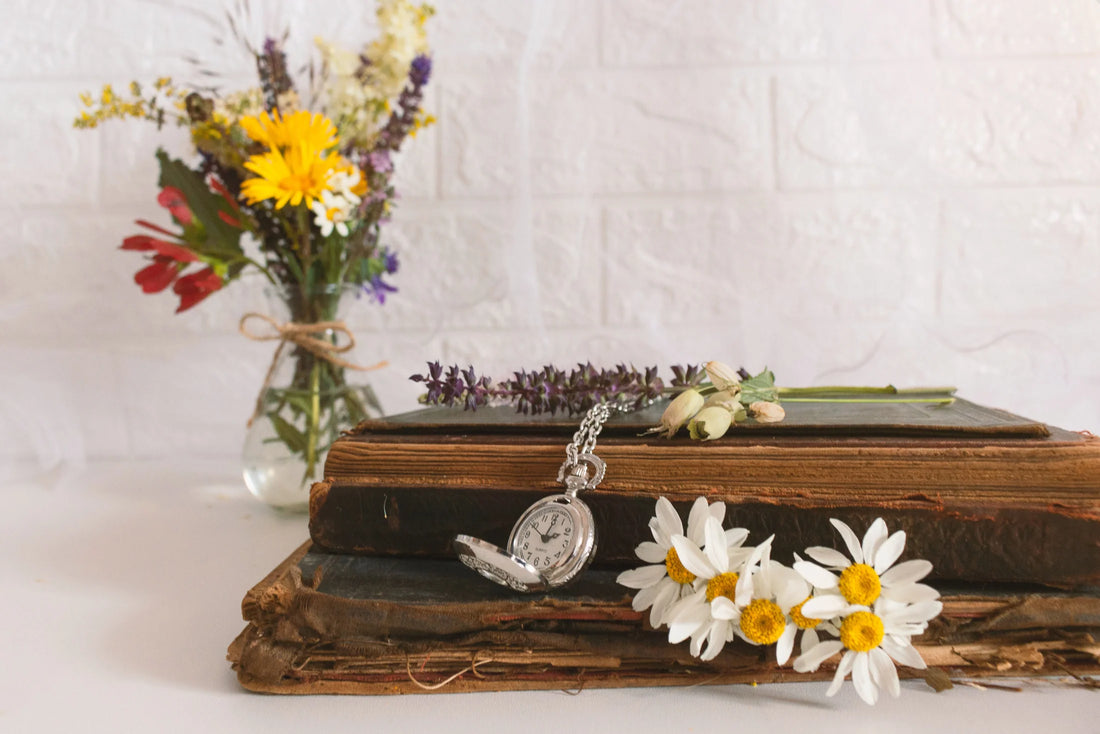 A personalized funeral display with florals and a pocket watch